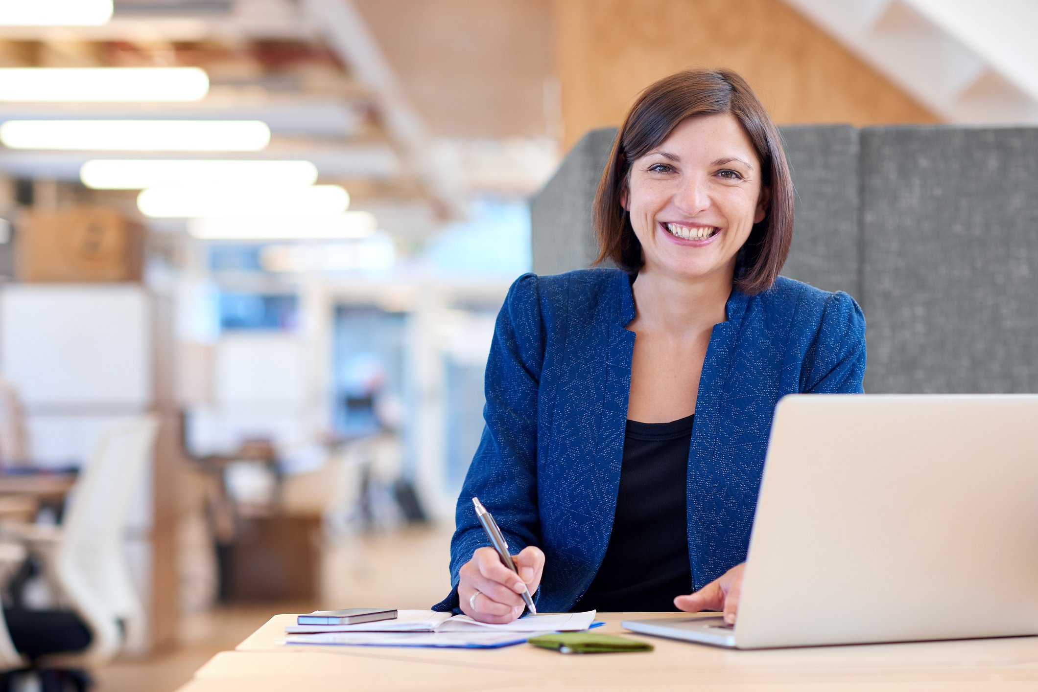 Woman smiling at her desk