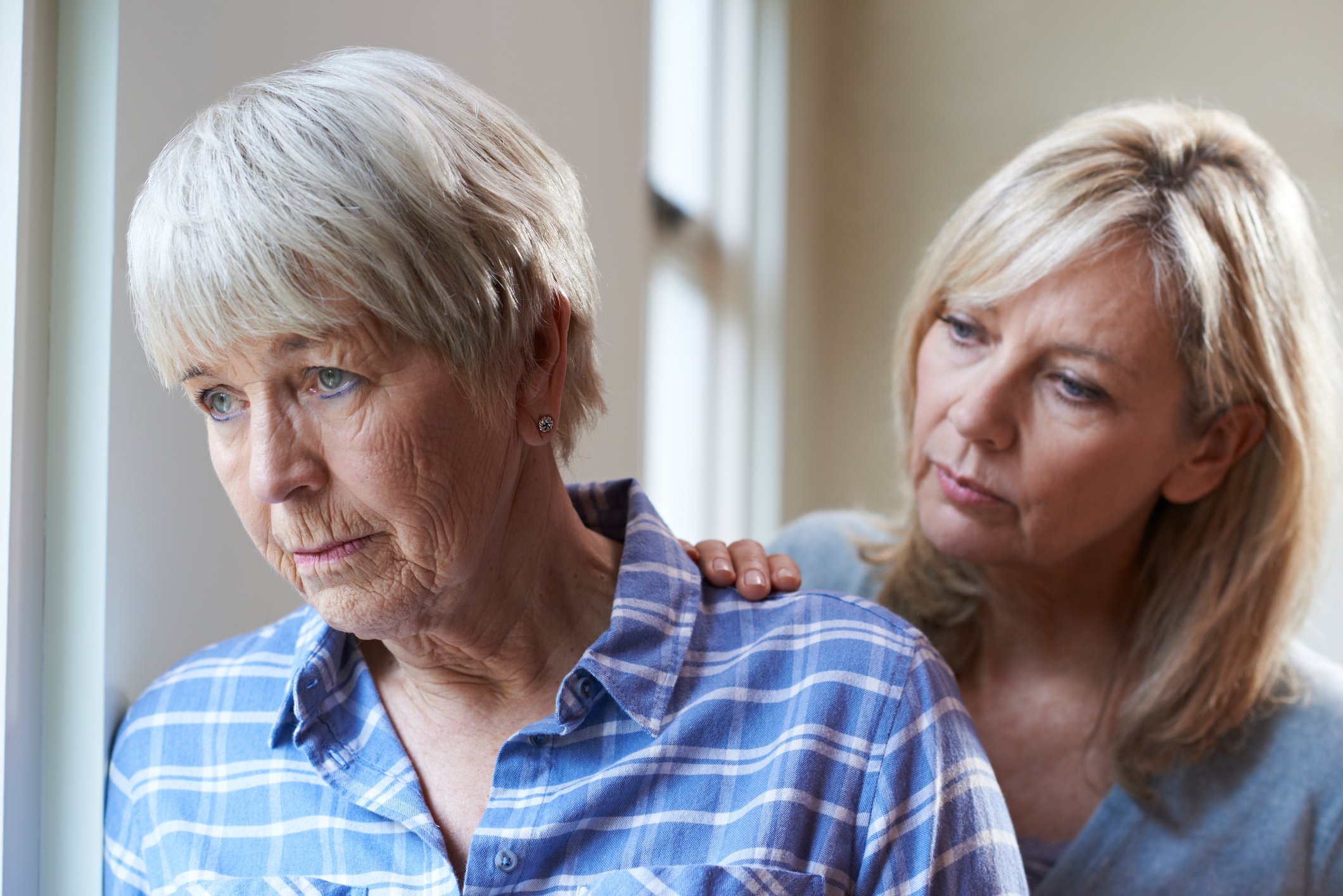 Woman comforting an older woman