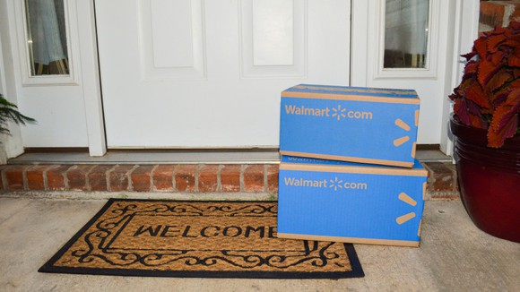 Two Walmart boxes stacked on a welcome mat