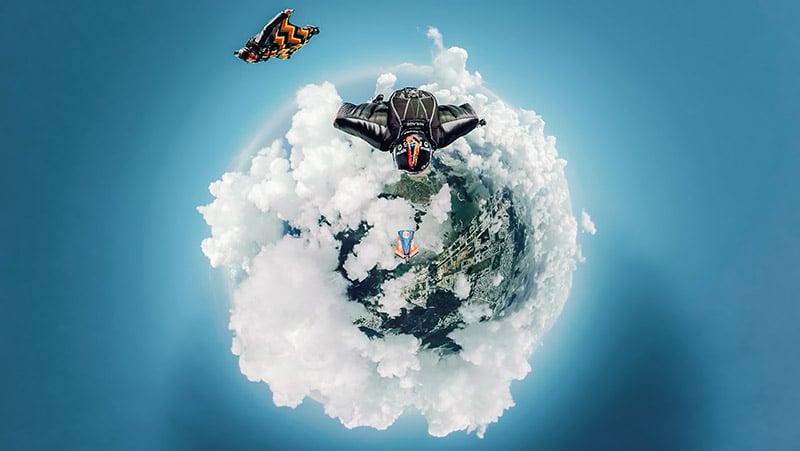 Tiny world photo of people skydiving. 