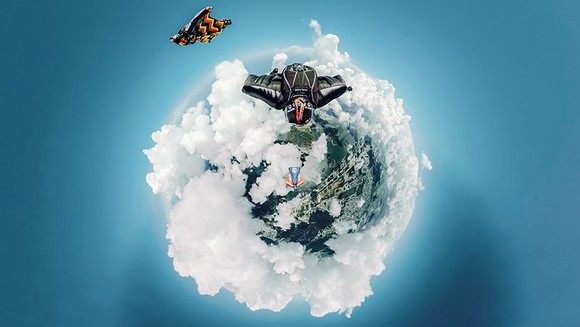 Tiny world photo of people skydiving. 