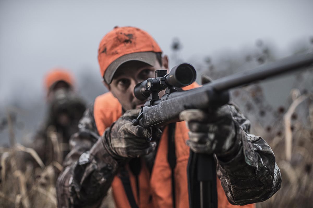 Hunter with scoped Remington rifle