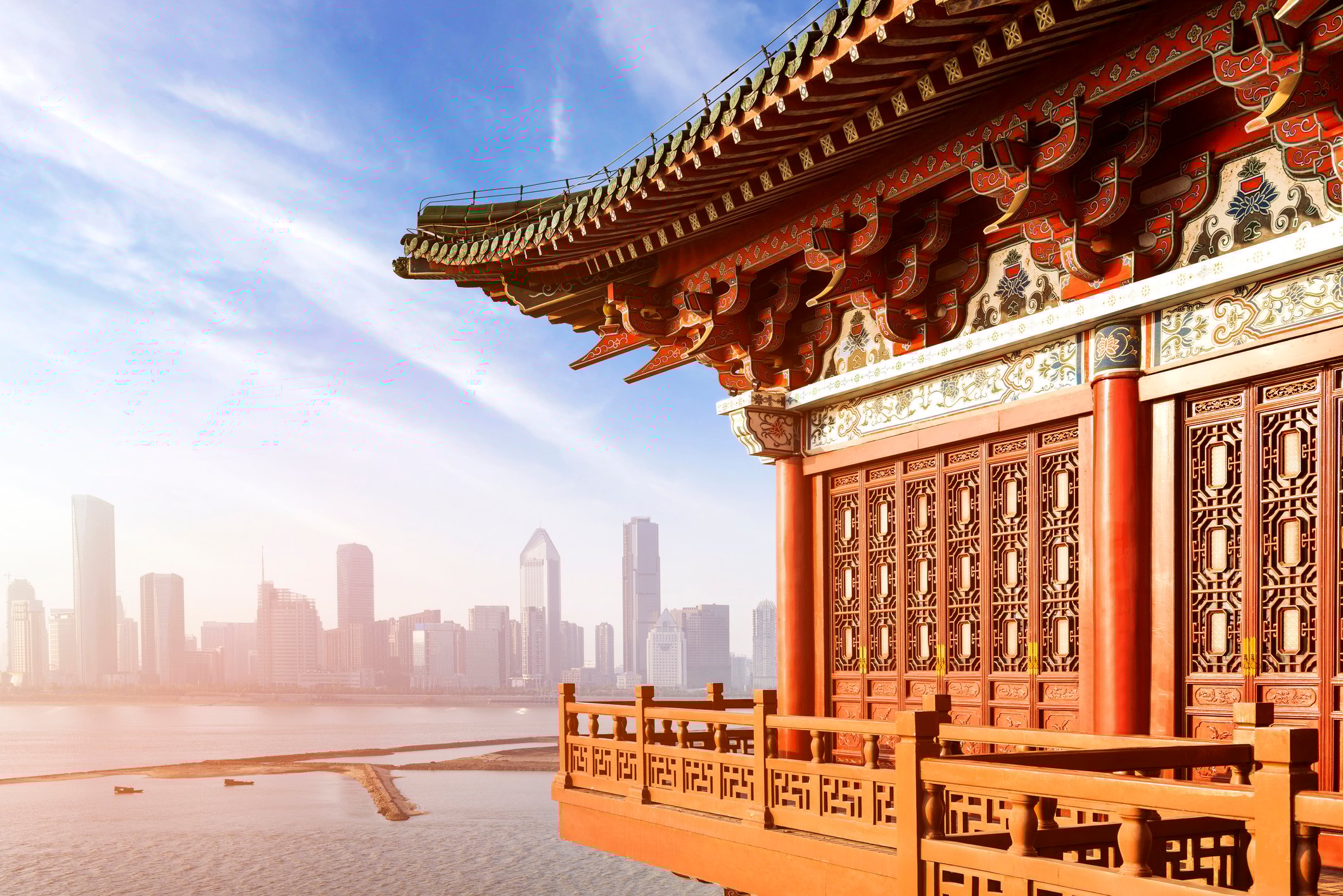 Ancient Chinese architecture with modern city skyline in the background