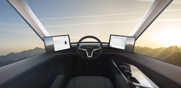 View from the interior of a Tesla Semi, showing driver seating in middle. 