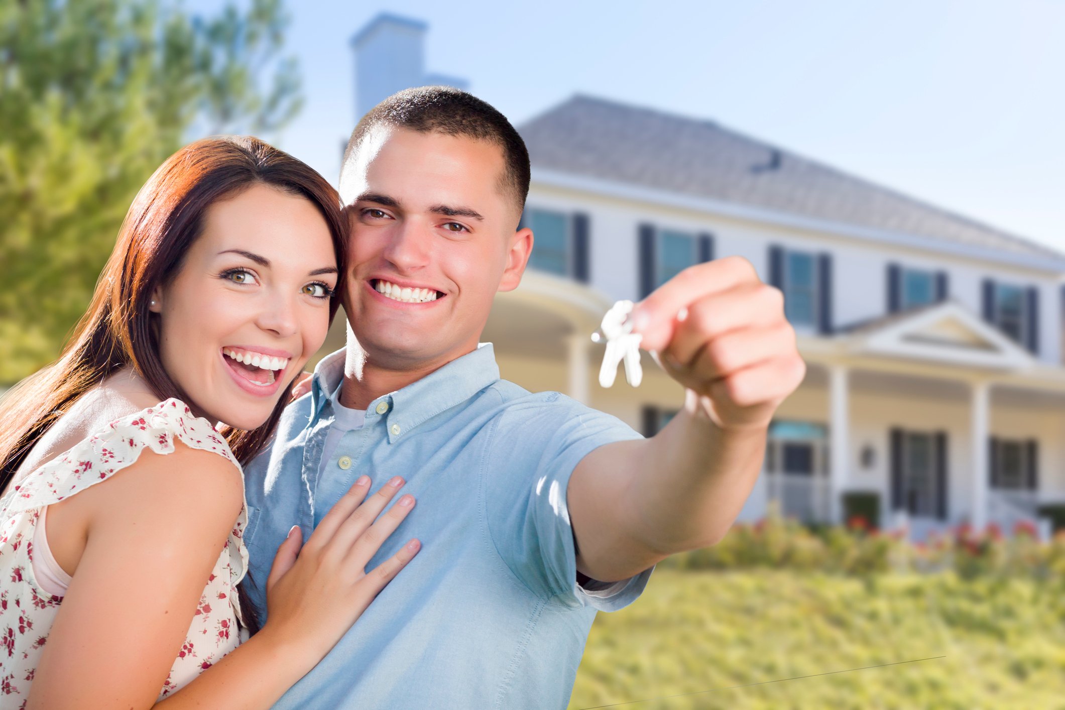 A couple showing keys to their new house