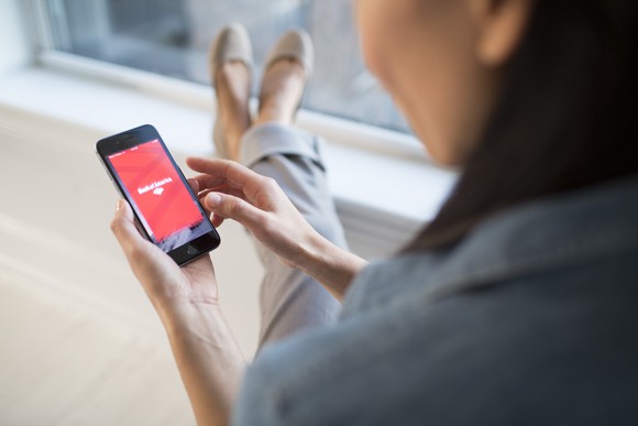A woman using Bank of America's mobile banking app.