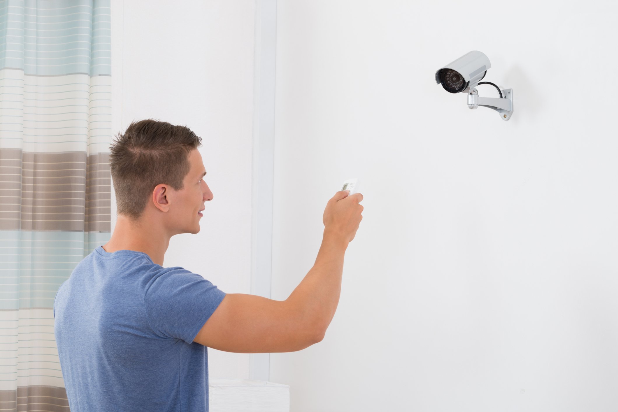 Man operating a security camera.