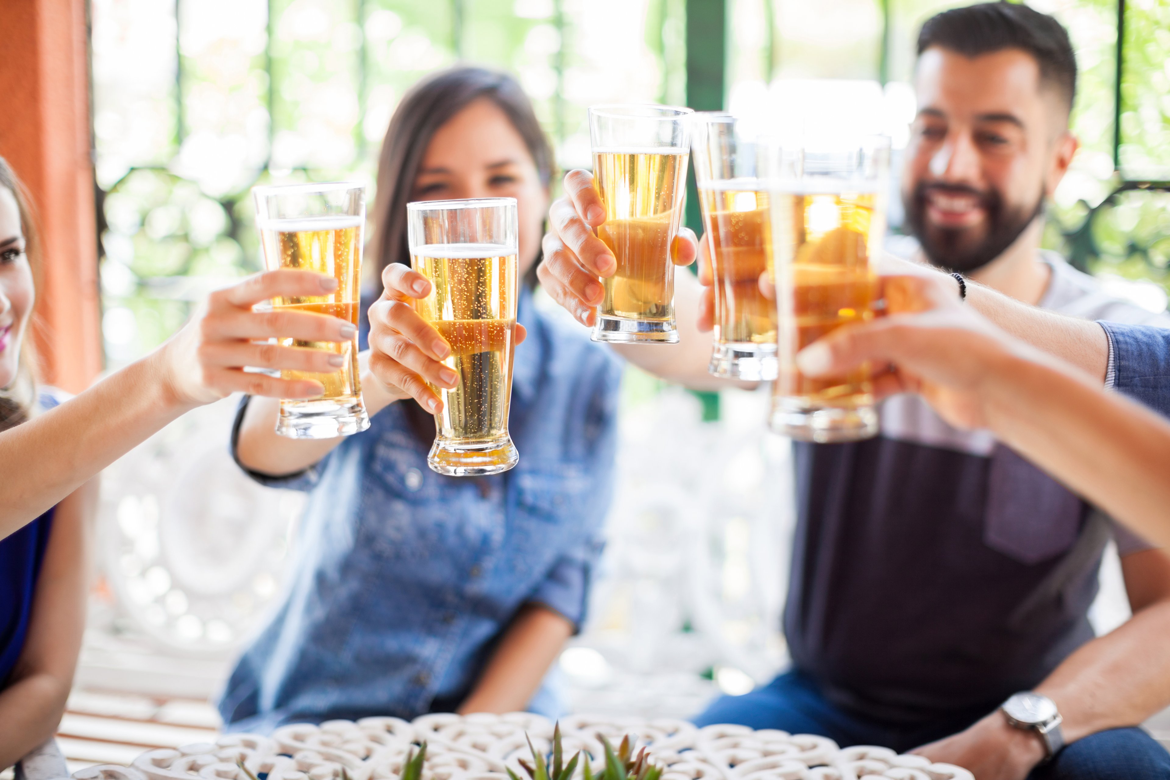 Group of friends toasting with glasses of beer.