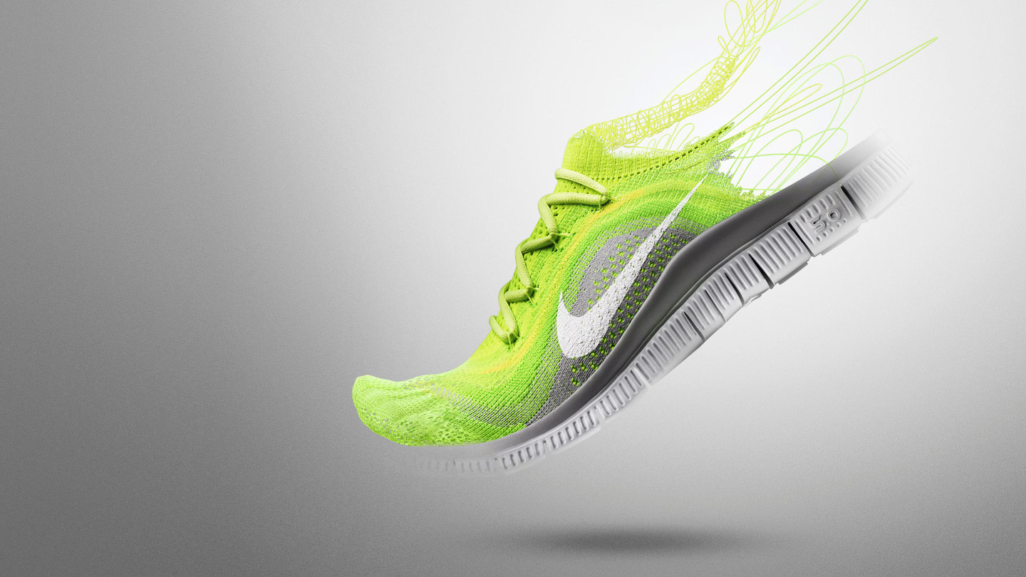 A flyknit sneaker in the middle of being constructed with half the shoe complete, and the other half with threads coming out of the back of the sneaker.