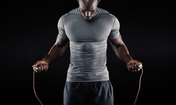 A man wearing athletic gear skipping rope