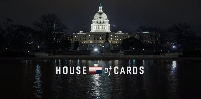 The House of Cards logo in front of the U.S. Capitol building at night