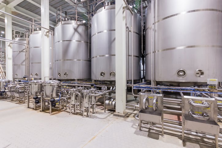 Stainless steel tanks in a biomanufacturing facility.