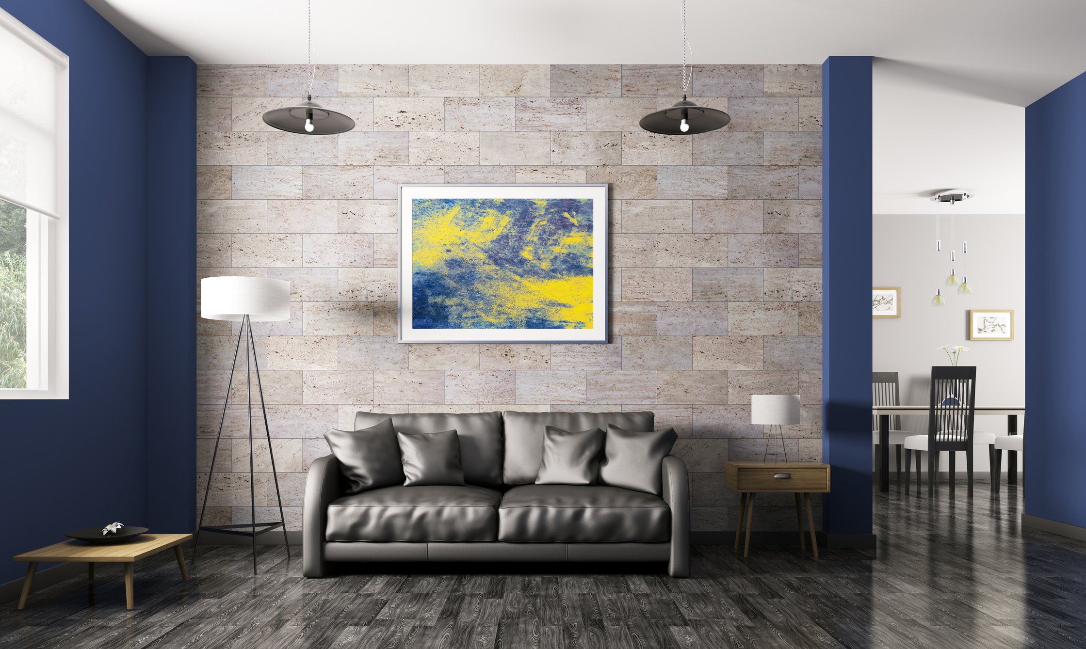 A blue and yellow painting hanging above a dark gray couch