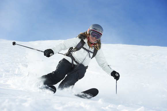 A skier heads down a snowy slope.