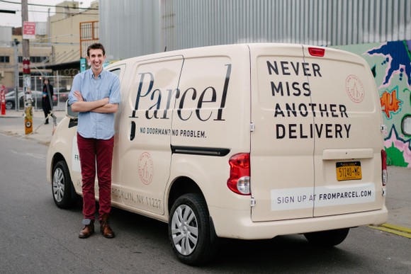 Parcel founder Jesse Kaplan stands in front of an off-white Parcel delivery van.