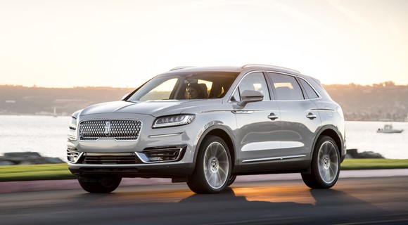 A silver 2019 Lincoln Nautilus, a midsize crossover SUV, on a waterfront road.