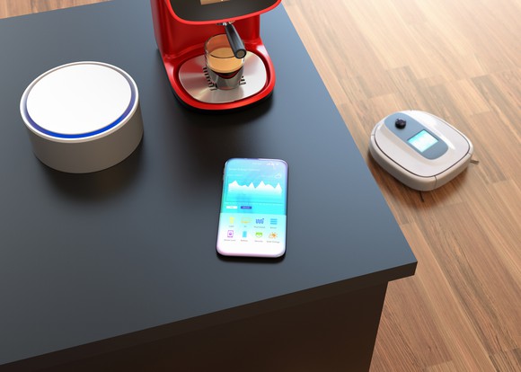 A smart home with a connected speaker, robotic vacuum, and smartphone