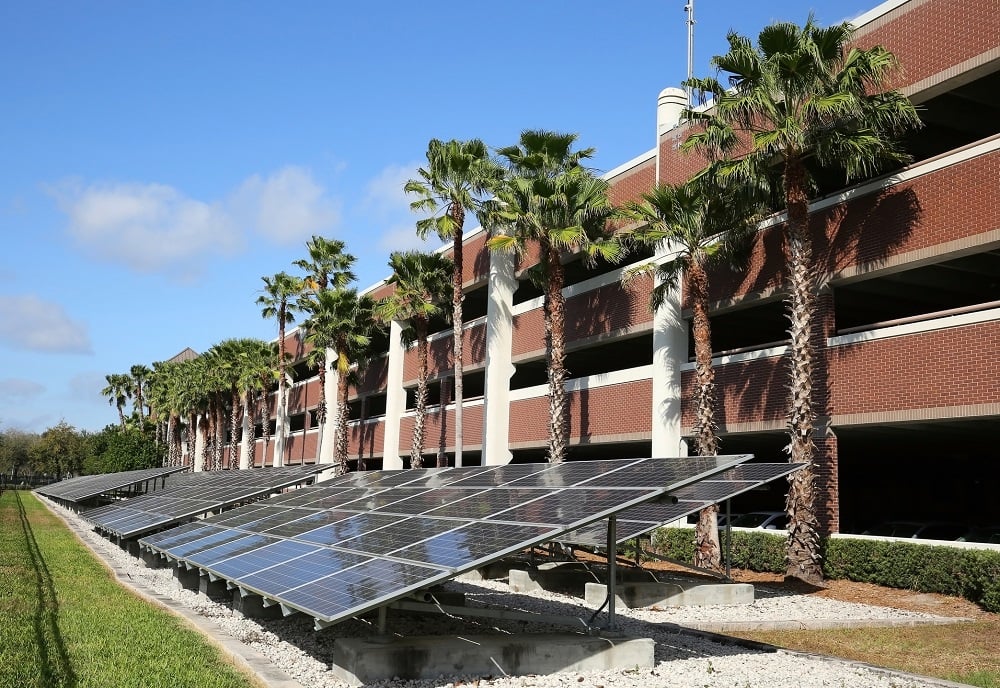 A solar-panel installation next to a parking structure