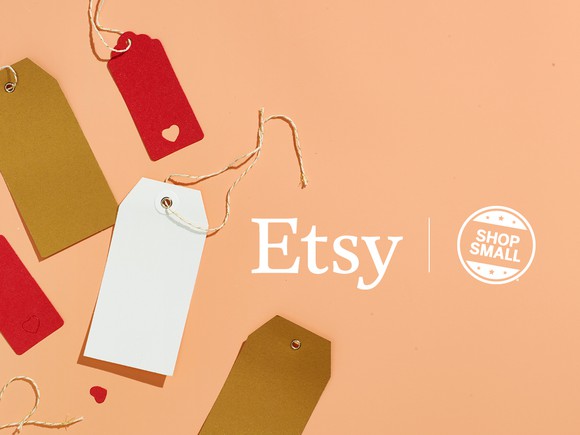 A promotional sign featuring blank tags on beige background to advertise Etsy for Small Business Saturday