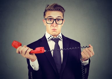 Shocked man with landline phone