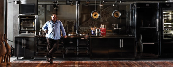 Acclaimed actor Gerard Depardieu standing in front of an AGA cooker.