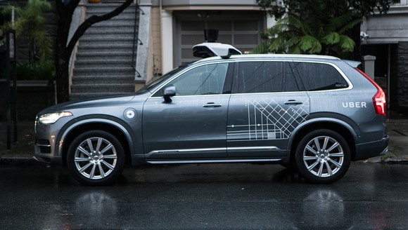 A grey Volvo SUV with Uber logo on it.