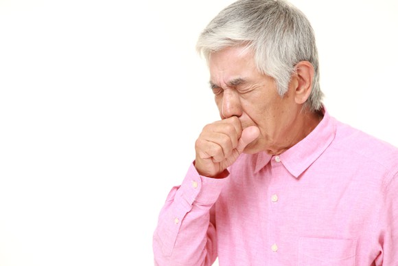 Senior man coughing