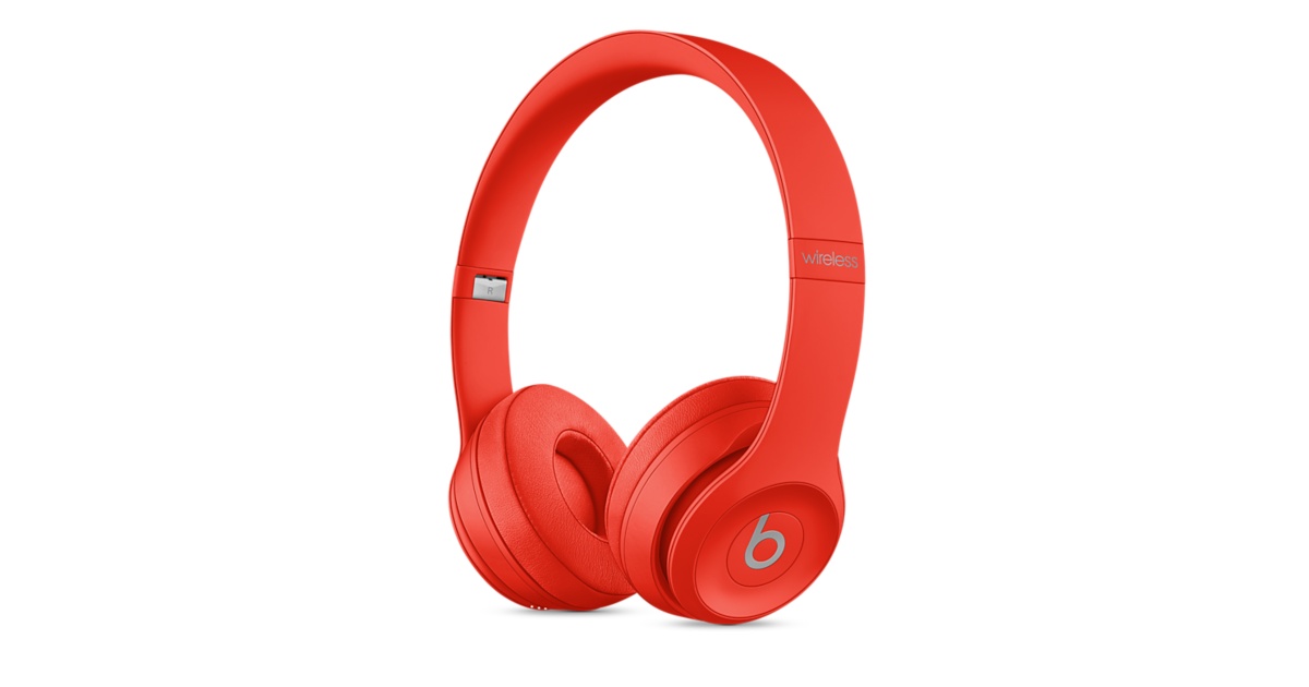 Red Beats headphones against a white background.