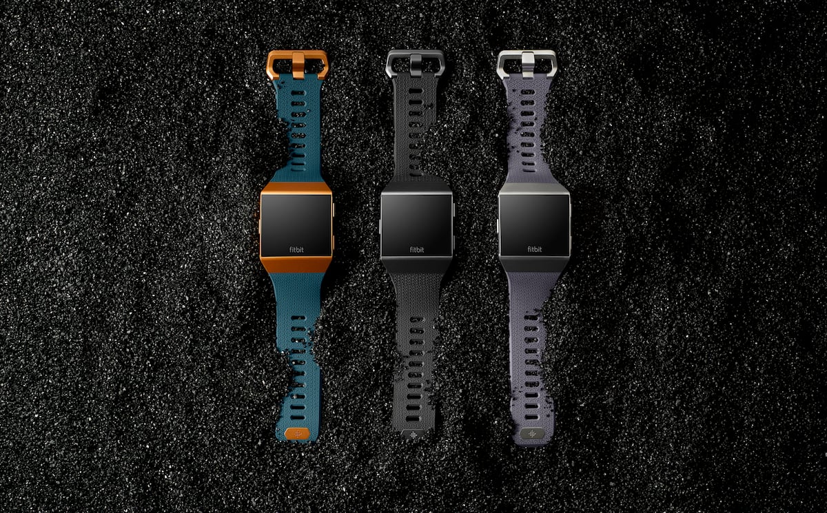 Three smartwatches laying next to each other.