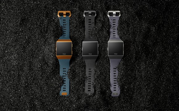 Three smartwatches laying next to each other.