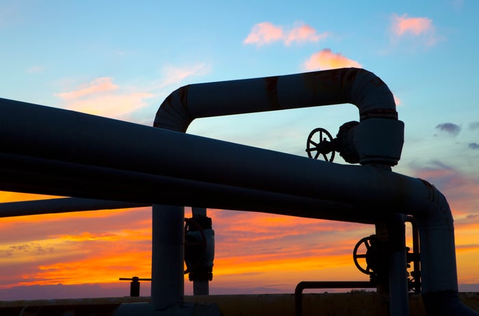 Sunset as seen through the twists of a pipeline system.