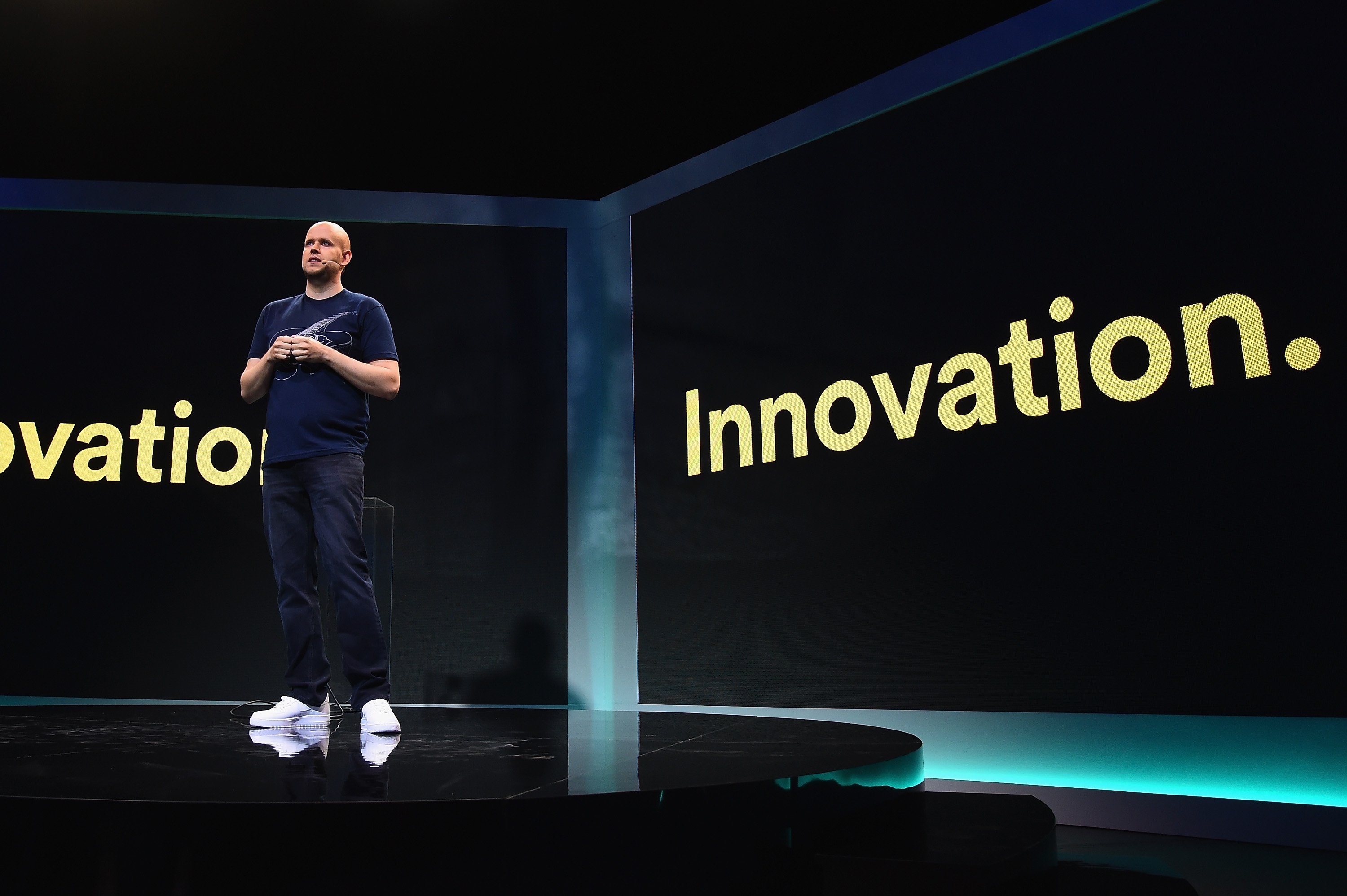 Spotify CEO Daniel Ek on stage in front of a slide that says "Innovation."