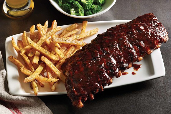 Applebee's ribs with a side of French fries, broccoli, and a beer.