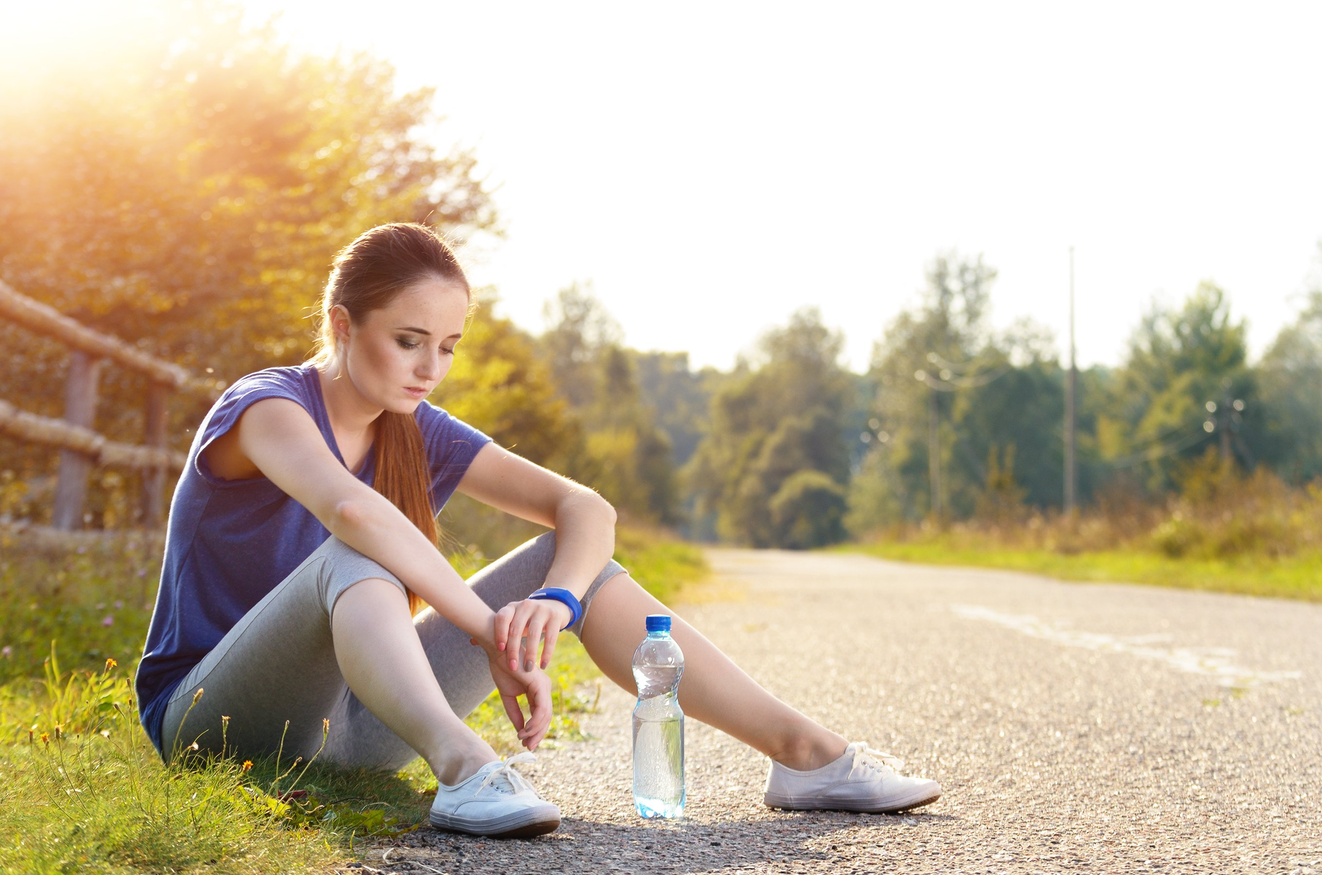 Jogger sitting down, looking glum, wearing a Fitbit