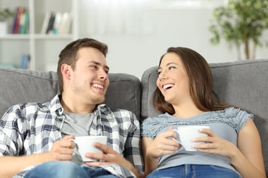 AG couple relaxing with coffee on the couch