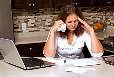 woman crying over bills_GettyImages-519750051