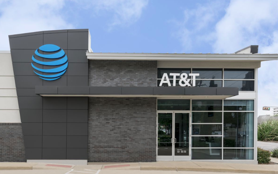 An AT&T retail storefront is shown with a blue sky in the background
