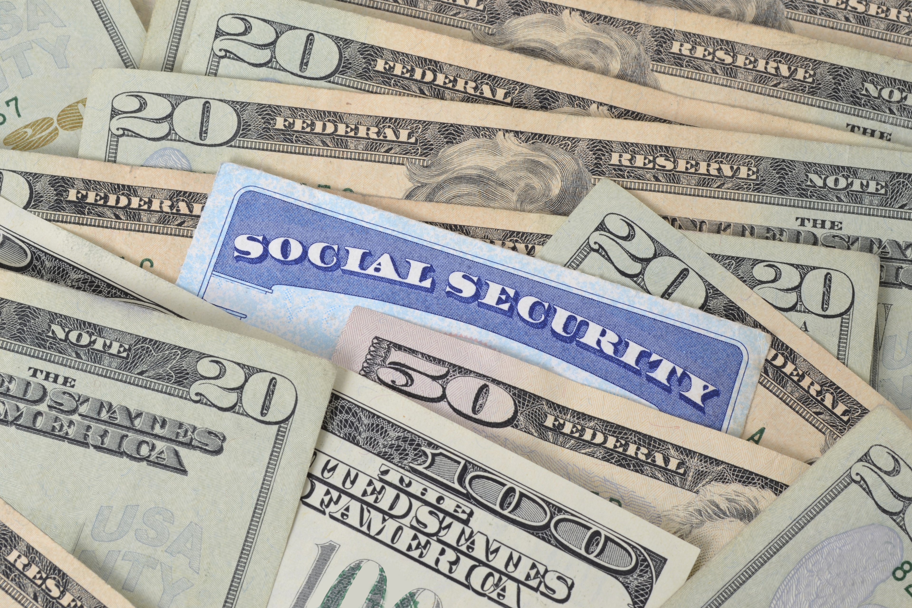 A Social Security card mixed in with a messy pile of cash.