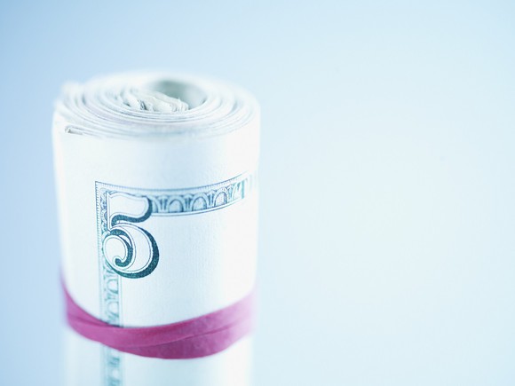 $5 bills wrapped in a rubber band.