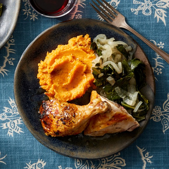 A plate of roast chicken and mashed sweet potatoes