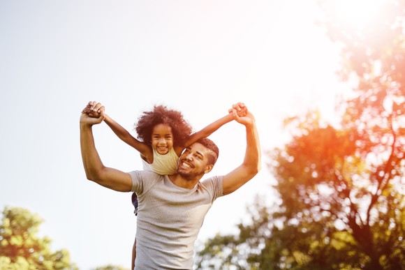 Father carrying daughter piggyback