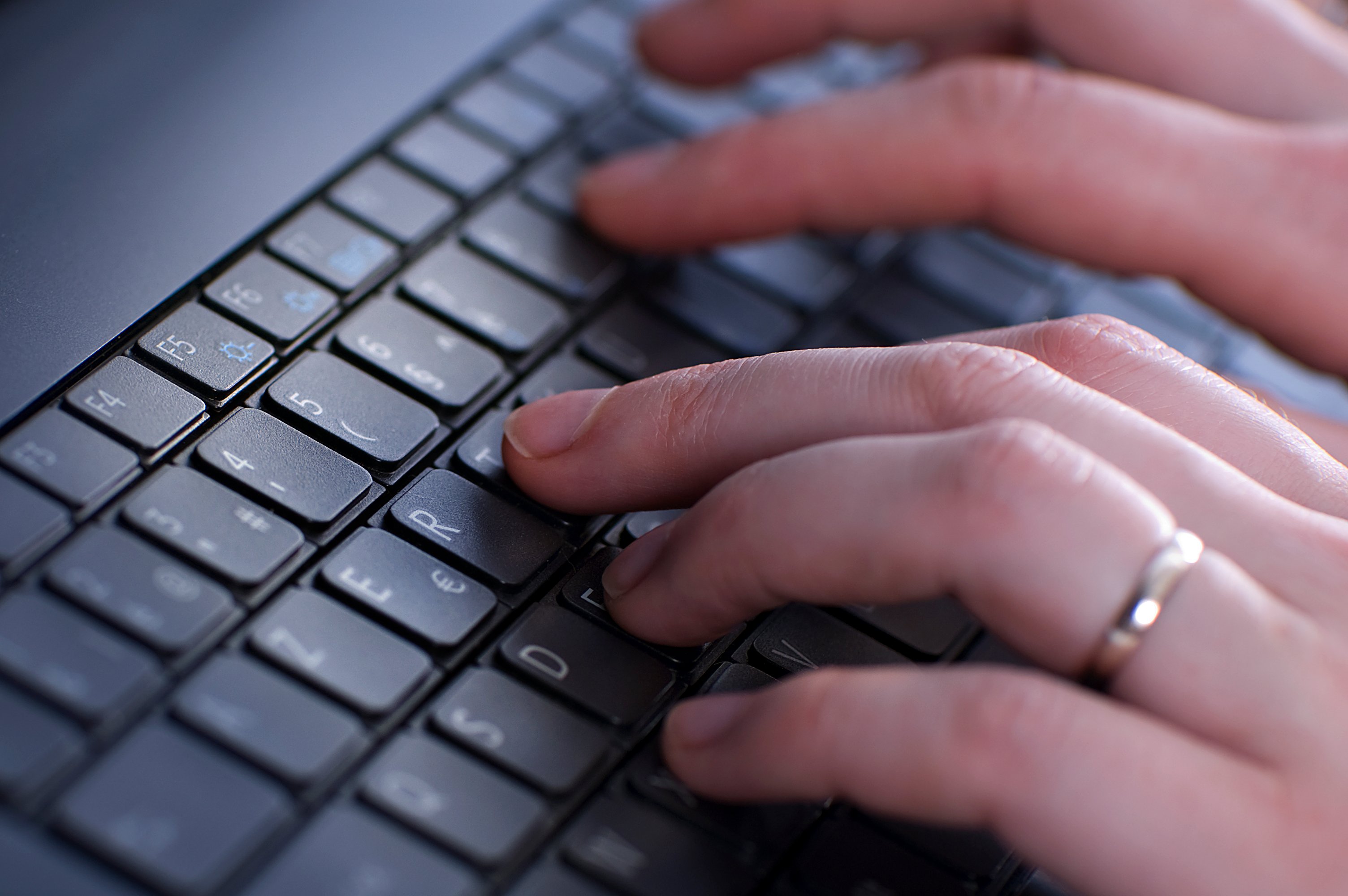 Hand typing on keyboard