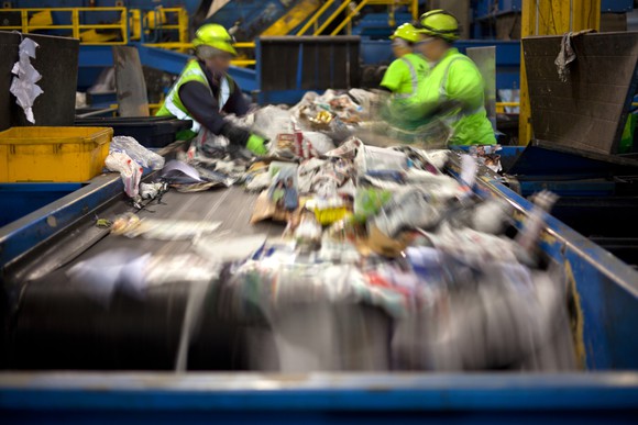 Employees on a waste management assembly line