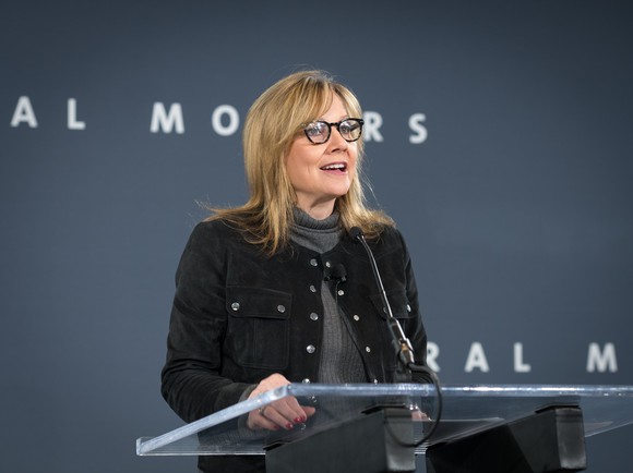 Barra is shown speaking at a podium in front of a "General Motors' backdrop.