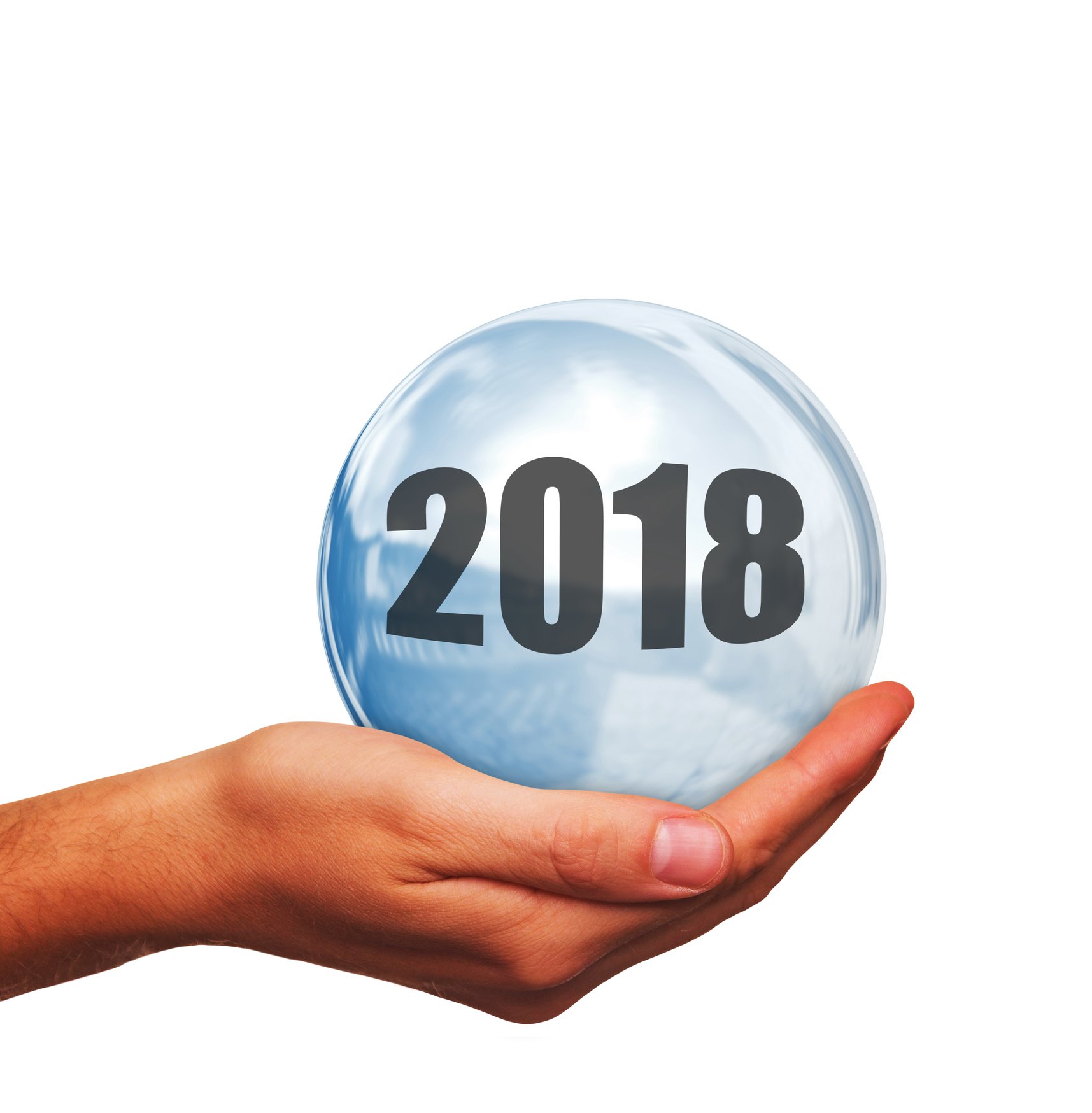 Person's palm-up hand holding a crystal ball with "2018" written on it. 