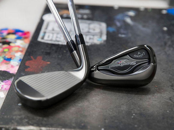 Two Callaway-branded irons, with heads shown on a black surface.