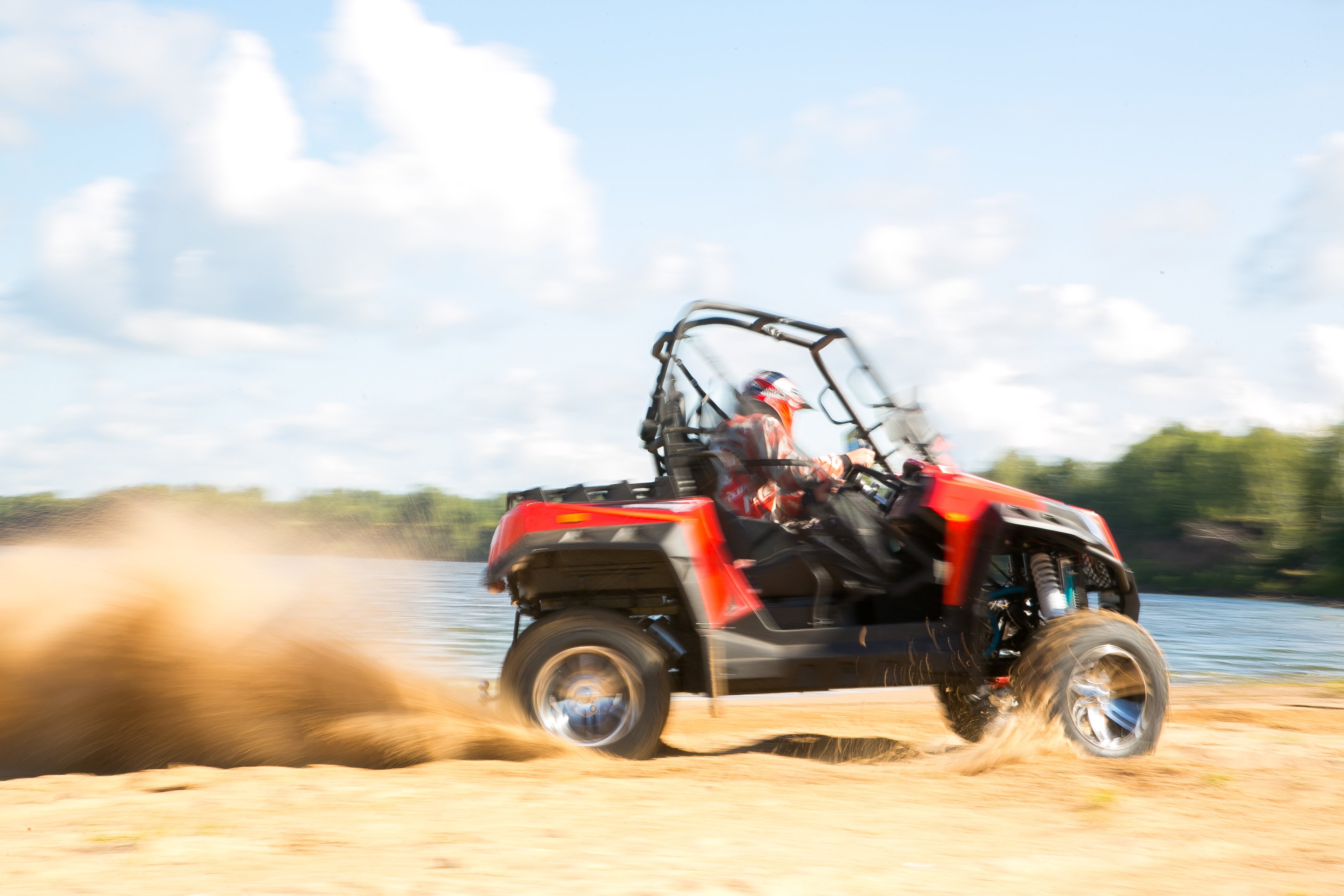 ATV riding on the sand during the day. 