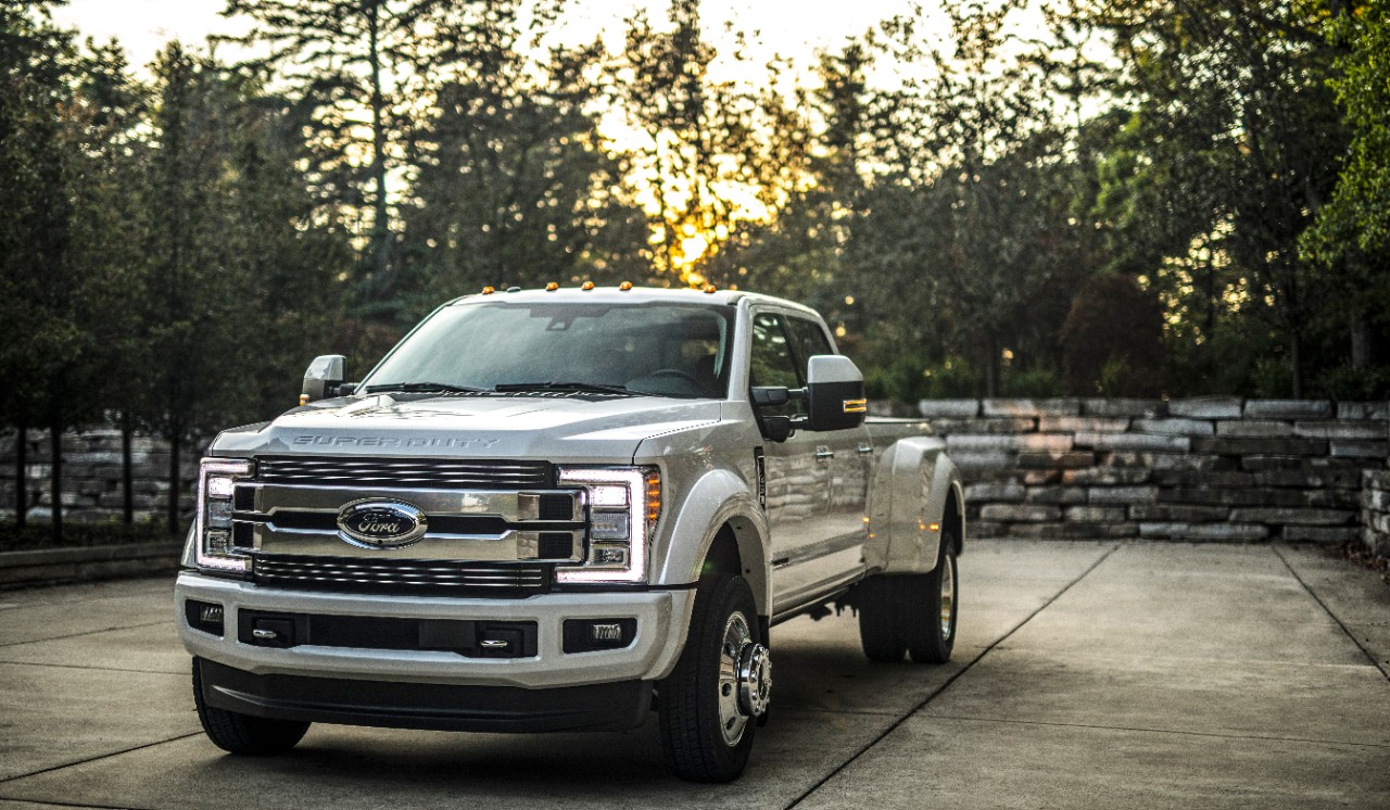 Ford's 2018 A silver F-Series Super Duty parked on a tree-lined driveway