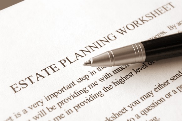 Paper labeled estate planning worksheet with instructions, and a pen on top.
