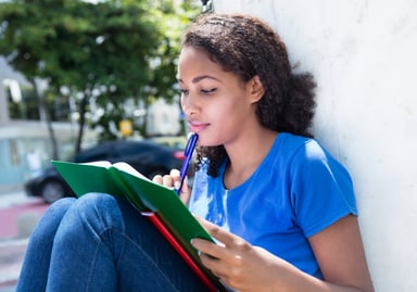 young female with book_GettyImages-614512092
